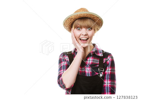 Shocked and surprised gardener woman in sun hat Shocked and surprised gardener woman in sun hat 127838123