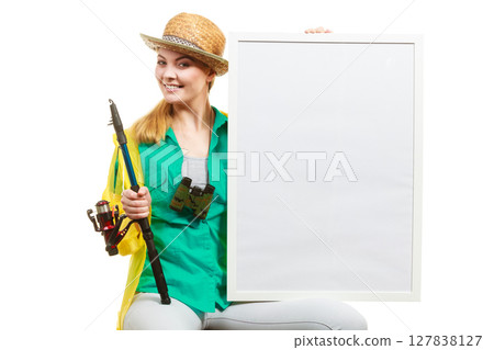 Happy woman with fishing rod holding board 127838127
