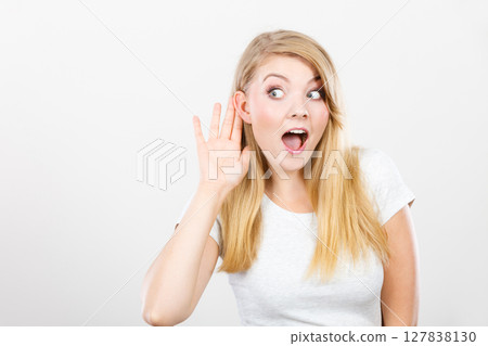 Woman putting hand ear to hear better 127838130