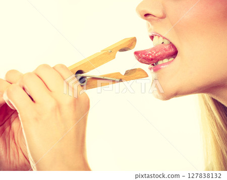 Blonde woman having tongue in clothespin 127838132