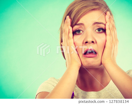 Tired woman with hands on face 127838134