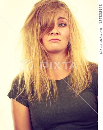 Sad blonde woman with messy hair 127838138