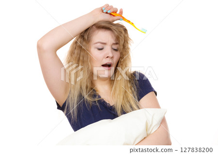 Sleepy woman hugging white pillow 127838200