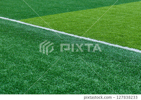 Close up of bright green artificial turf and crisp white markings. High quality photo 127838233