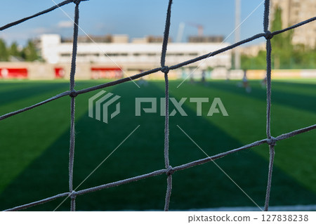 The view through a soccer goal net at a local field. High quality photo The view through a soccer goal net at a local field. High quality photo 127838238