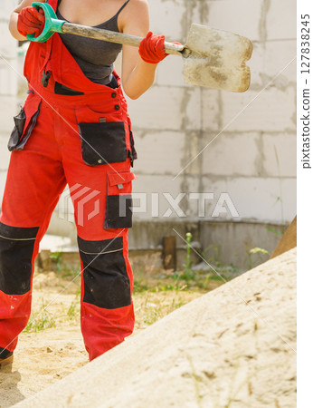 Woman using shovel on constriction site 127838245
