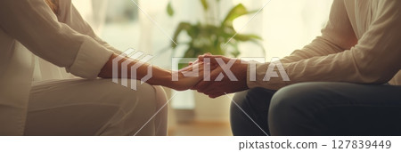 Female doctor supports her patient during therapy in a sunny medical office, showing the importance of emotional care in healthcare 127839449