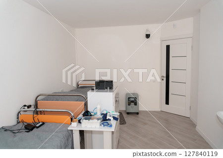 Polysomnography Room Setup with Hospital Bed, Monitoring Equipment, and White Door in a Clean, Brightly Lit Clinical Environment Polysomnography Room Setup with Hospital Bed, Monitoring Equipment, and White Door in a Clean, Brightly Lit Clinical Environment 127840119