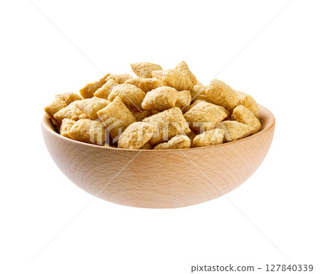 wooden bowl of tasty corn pads isolated on a white background. wooden bowl of tasty corn pads isolated on a white background. 127840339