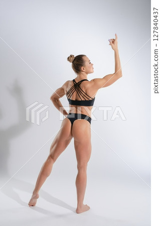 Woman showcasing fitness and strength in stylish lingerie and a dynamic pose Woman showcasing fitness and strength in stylish lingerie and a dynamic pose 127840437