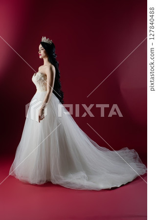 Graceful bride in luxurious lingerie inspired gown against a vibrant backdrop 127840488