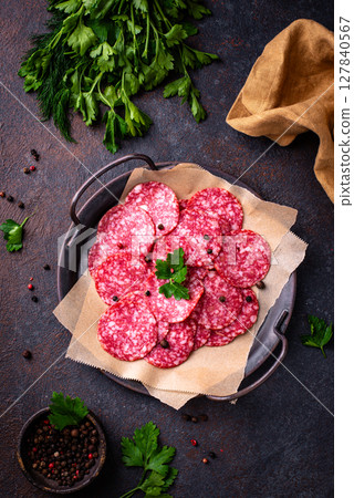 Sliced spicy tasty salami sausage 127840567