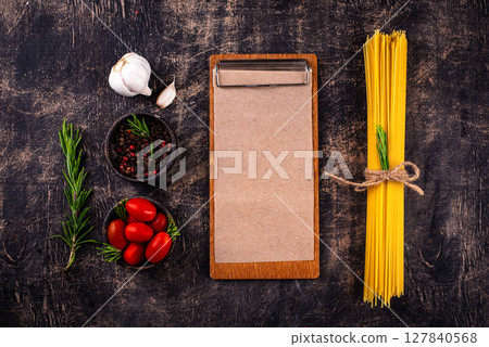 Italian food background with spaghetti, tomato and spices 127840568