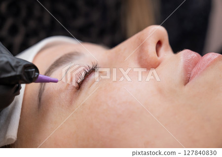 The process of professional eyelash lamination in a salon.  127840830