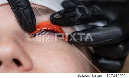 The process of professional lamination and tinting of eyelashes in the salon. The process of professional lamination and tinting of eyelashes in the salon. 127840931