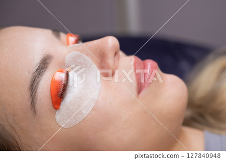 Caucasian woman undergoing eyelash lamination procedure. Caucasian woman undergoing eyelash lamination procedure. 127840948