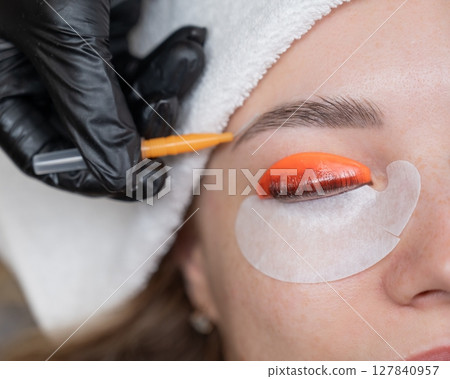 Caucasian woman undergoing eyelash lamination procedure. Caucasian woman undergoing eyelash lamination procedure. 127840957