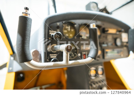 Dashboard yellow airplane glider in hangar.  127840964
