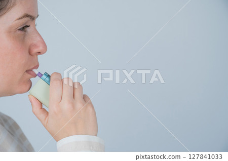 Caucasian woman smoking electronic cigarette. Tobacco heating system. Caucasian woman smoking electronic cigarette. Tobacco heating system. 127841033