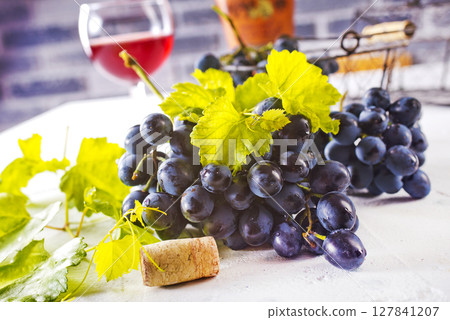 Red wine grapes on white table Red wine grapes on white table 127841207
