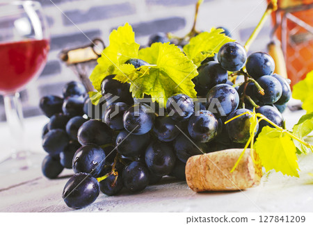 Red wine grapes on white table Red wine grapes on white table 127841209