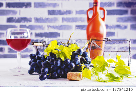 Red wine grapes on white table Red wine grapes on white table 127841210