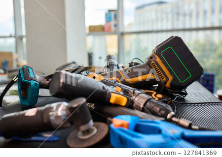A Wide Variety of Different Tools Displayed on a Workbench in a Modern Workspace Environment 127841369