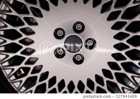 Detailed shot of a sleek black and silver alloy wheel on a motor vehicle Detailed shot of a sleek black and silver alloy wheel on a motor vehicle 127841409