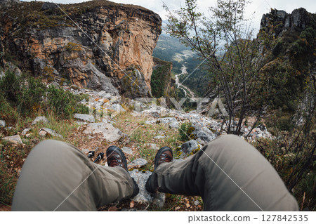 POV of backpacking woman climbing up on steep cliff edge at high altitude mountains top POV of backpacking woman climbing up on steep cliff edge at high altitude mountains top 127842535