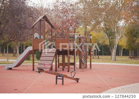 Colorful Wooden Playground Equipment Set In A Beautiful Autumn Park Setting 127844250