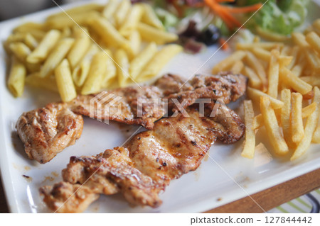 Grilled Chicken with Pasta, Fries, and Fresh Salad on a White Plate Grilled Chicken with Pasta, Fries, and Fresh Salad on a White Plate 127844442