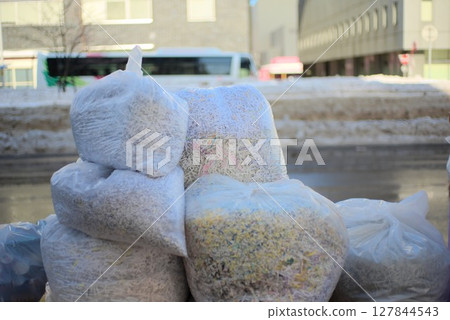 Garbage bag filled with shredded paper Garbage bag filled with shredded paper 127844543