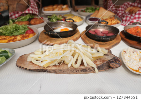 Delicious cheese platter with various dishes on the table Delicious cheese platter with various dishes on the table 127844551