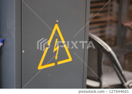 Warning sign on electrical cabinet in industrial location 127844681