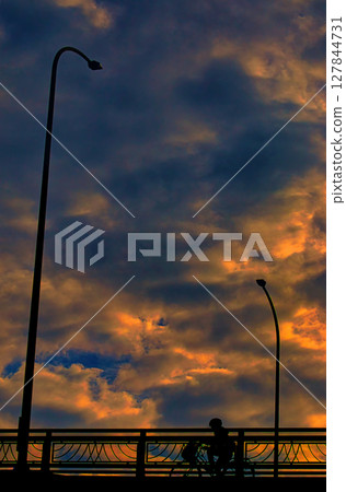 Sunset sky, clouds and bicycle Sunset sky, clouds and bicycle 127844731