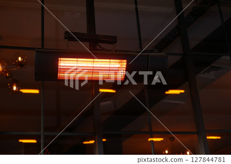Modern infrared heater warming a stylish indoor space 127844781