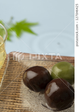 Red bean paste balls on a glass plate creating a cool atmosphere at the waterside Red bean paste balls on a glass plate creating a cool atmosphere at the waterside 127846425
