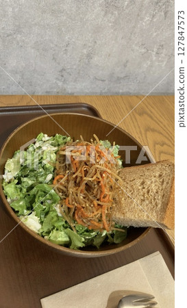 Salad bowl - topped with brown rice bread and kinpira burdock Salad bowl - topped with brown rice bread and kinpira burdock 127847573