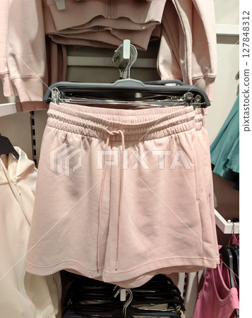 soft pink shorts displayed in retail store for casual summer wear. closeup. soft pink shorts displayed in retail store for casual summer wear. closeup. 127848312
