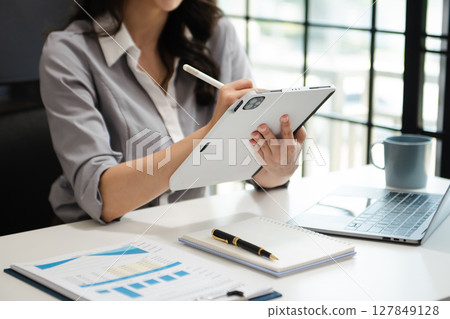 business woman using laptop computer at modern office with blurred background business woman using laptop computer at modern office with blurred background 127849128