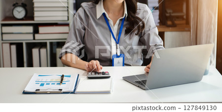Businessman hands working with finances about cost and calculator and laptop with tablet, smartphone at office Businessman hands working with finances about cost and calculator and laptop with tablet, smartphone at office 127849130