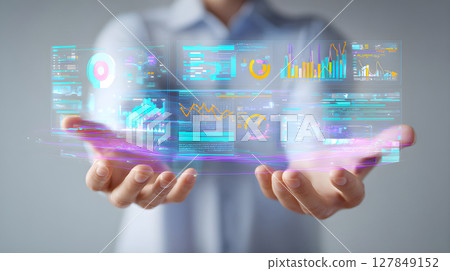 Futuristic data visualization interface in hands. Businessman holding virtual analytics dashboard. Modern AI-driven data analysis concept. Holographic big data and business intelligence tools. 127849152