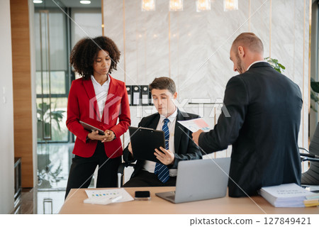 Young business creative team are brainstorming planning discussing while sitting in creative business discussing work in the office 127849421