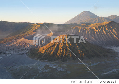 The morning view of the sun shining on Bromo volcano Indonesia in long distance. 127850551