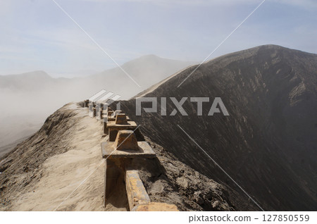 View from crater rim seats and safety barriers for sightseeing tourists, Bromo Mountain, Indonesia View from crater rim seats and safety barriers for sightseeing tourists, Bromo Mountain, Indonesia 127850559