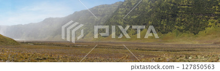 Indonesia's mighty Volcano Bromo stands tall in the middle of the desert. 127850563