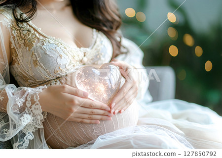 Pregnant woman holding a heart 127850792
