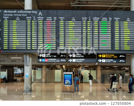 Suwannabhumi Airport, Thailand, Apr14th, 2024 Airport interior with passengers checking a large digital flight arrival information board for updates Suwannabhumi Airport, Thailand, Apr14th, 2024 Airport interior with passengers checking a large digital flight arrival information board for updates 127850804