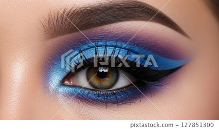 Vibrant Blue and Purple Smokey Eye Makeup Closeup with Dramatic Winged Eyeliner 127851300