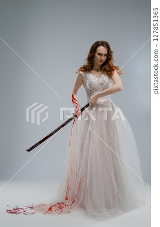 Bridal beauty in lingerie holding a katana with traces of blood 127851365
